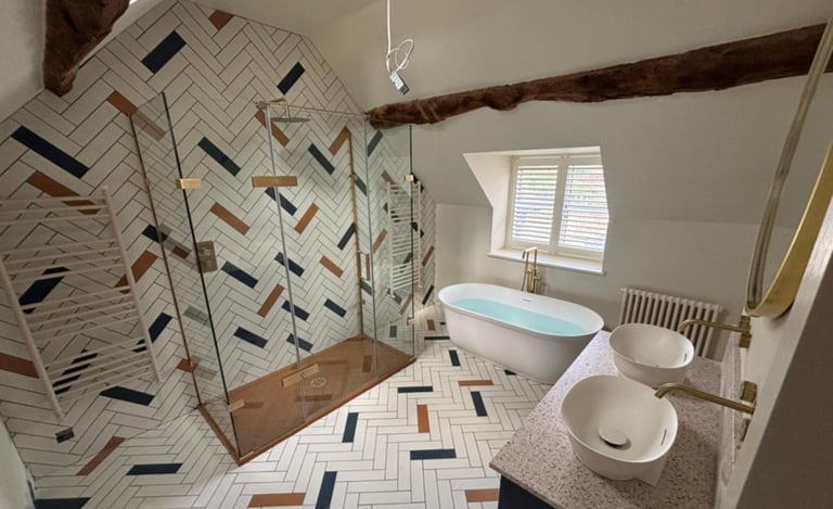 Modern bathroom installation with freestanding bath and tiled walls in Evesham