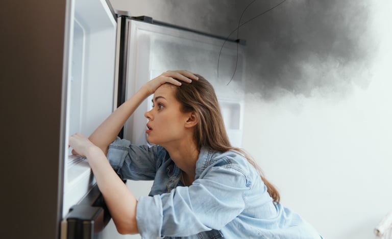 Mulher olhando frustrada pra geladeira com defeito
