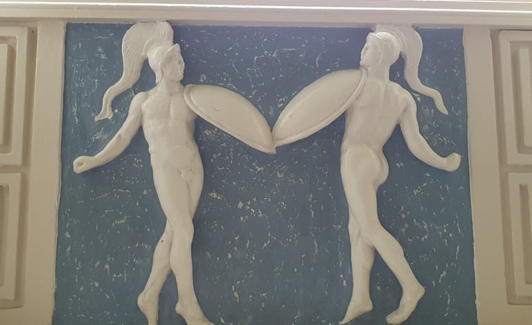 Two dancers depicted in the plaster decoration at Braxted Park