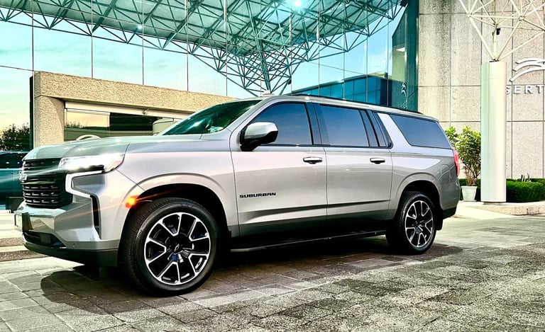 a silver suv parked in front of a building