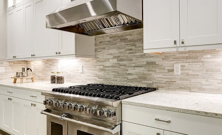 a kitchen with a stove top oven and a range hood