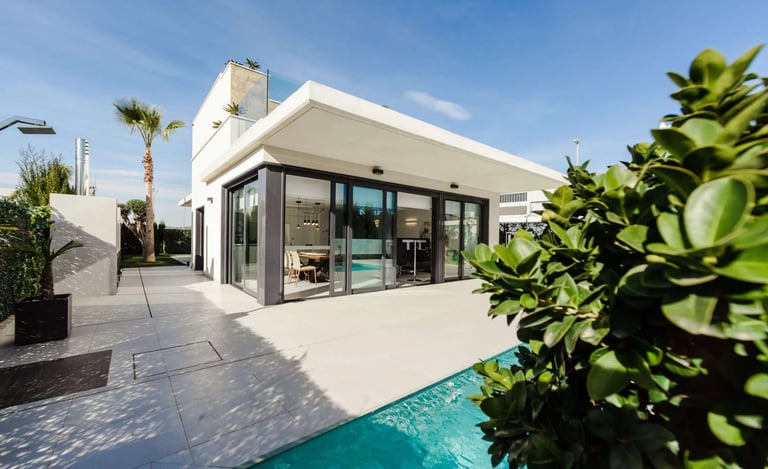 a house with a pool and a pool in the background