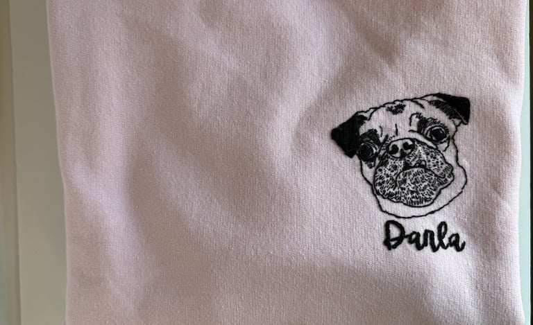 a pink shirt with a pug dog on it