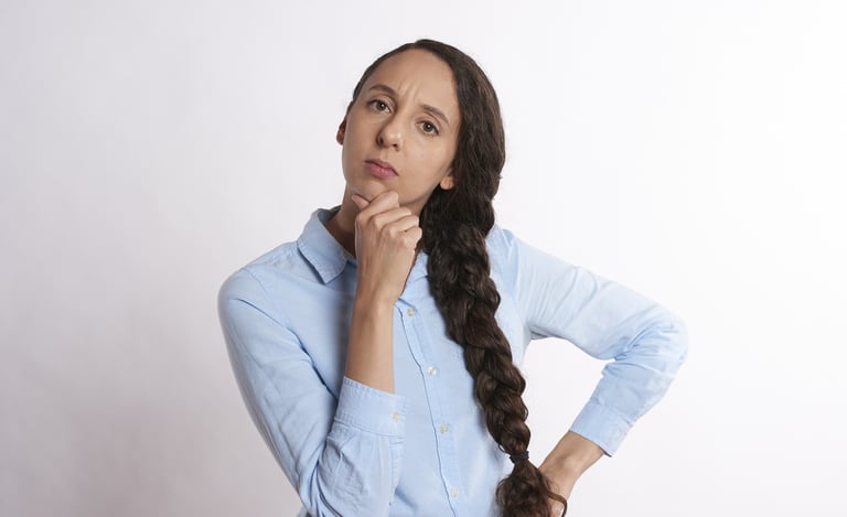 woman thinking thoroughly and wondering if gold ira is a scam