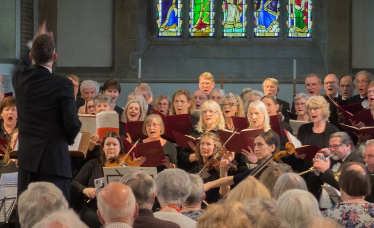 Photo of Steven Kings conducting a choir and orchestra