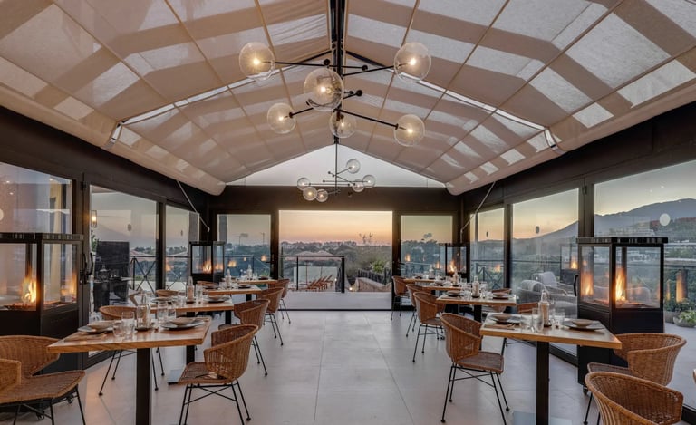 Covered terrace dining area with mountain and sunset views