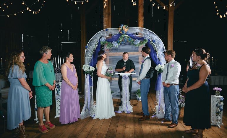 a bride and a groom getting married in a barn