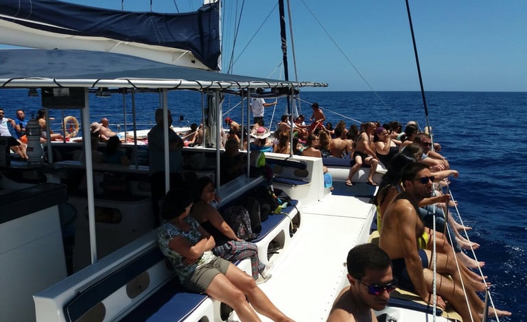 Tourists on Sea Born catamaran deck at Cabo Girão.