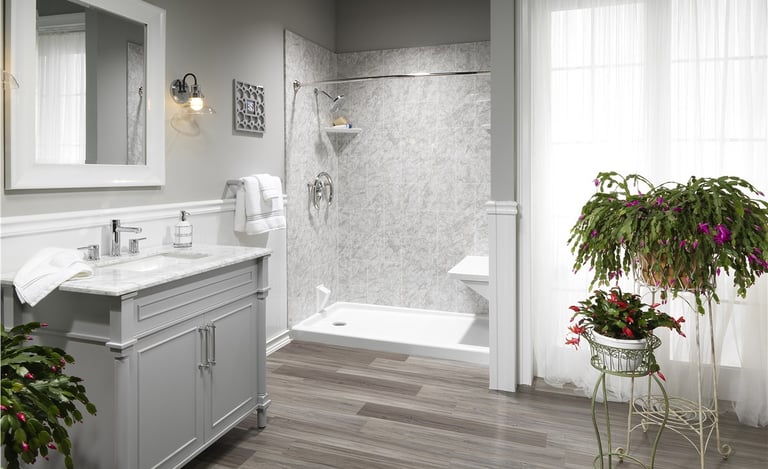 Elegant walk-in shower with marble walls and gray vanity from Toledo New Bath bathroom remodel.