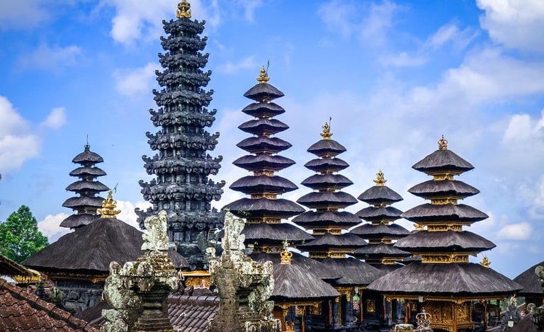 Besakih Temple gates made of black volcanic stone against a clear blue sky