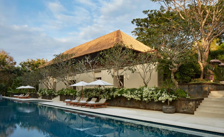 Luxury Aman Villa at Nusa Dua, Bali, featuring a private infinity pool, tropical garden, and modern Balinese architecture 