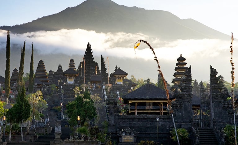 Besakih Temple gates made of black volcanic stone against a clear blue sky