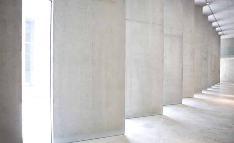 a room with a large window and a wall with a long row of stairs