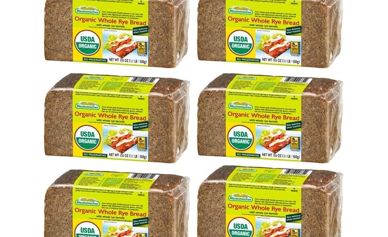 Six loaves of Mestemacher Organic Whole Rye Bread in clear plastic packaging with USDA Organic labels.