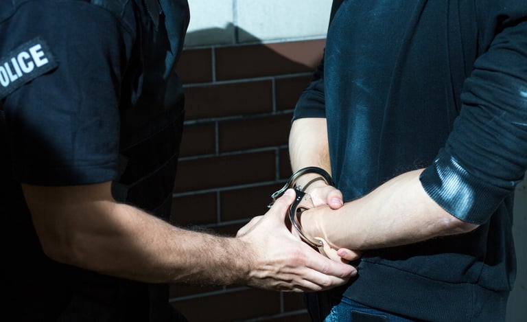 police officer putting handcuffs on a man