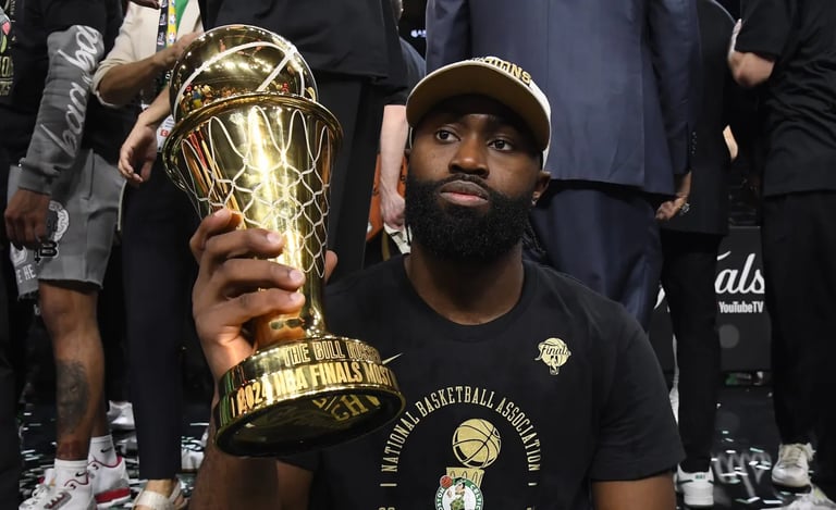 Jaylen Brown posing with his NBA Finals MVP (2024).