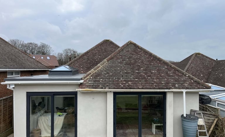 Completed bungalow rear extension with large sliding doors and modern exterior finish.