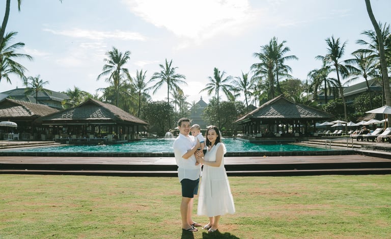 Couple standing in tropical garden at Intercontinental Jimbaran during a relaxed family photography session in Bali