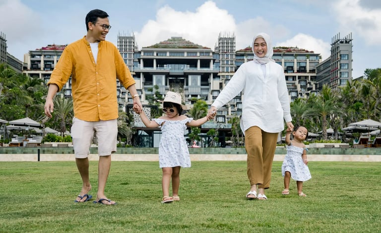 Muslim family walking together on the Ocean Lawn at The Apurva Kempinski Bali