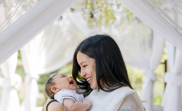 Mother embracing her baby inside a suite at Samabe Bali Suites & Villas in Nusa Dua.