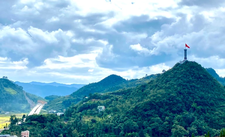 a flag flying over a mountain