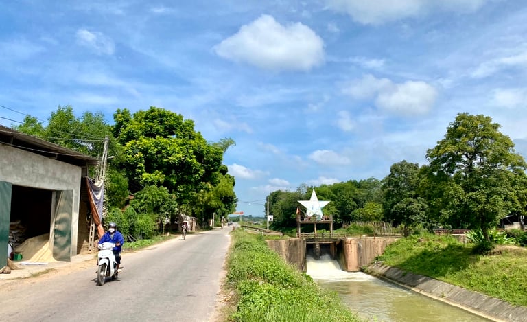 a person riding a motorcycle down a narrow road