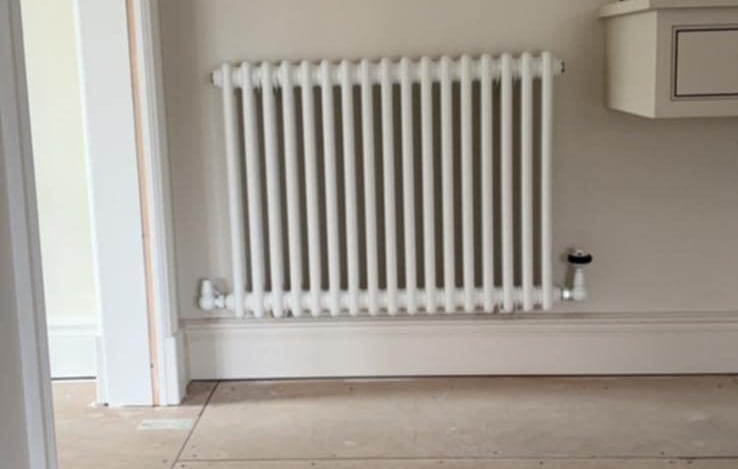 double-panel radiator being leveled and tested by PBP Services in Pershore