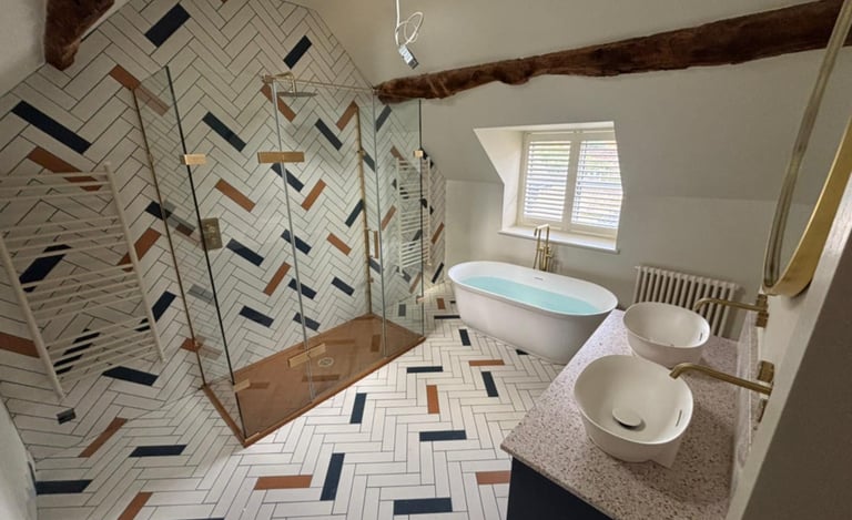 Modern bathroom installation with freestanding bath and tiled walls in Evesham