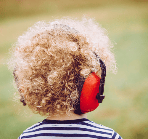 Child wearing noise-canceling headphones to support sensory regulation and ADHD calm-down strategies