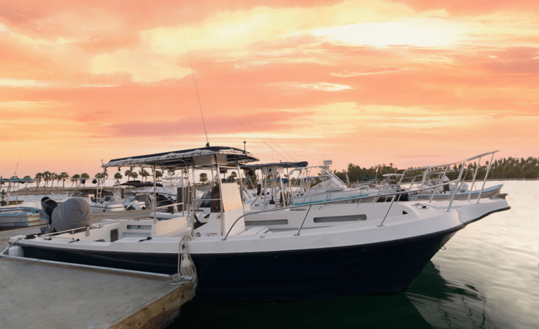 a boat docked at a dock with a man standing next to it