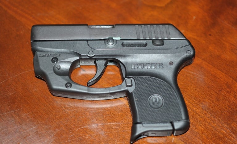 Ruger LCP with laser laying on a wood table