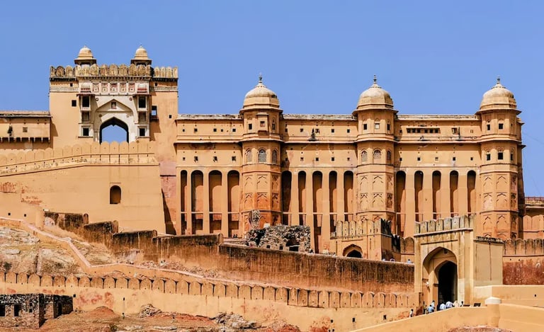 See the grand facade of Amber Fort in Jaipur, a UNESCO World Heritage site known for its majestic Rajput architecture.