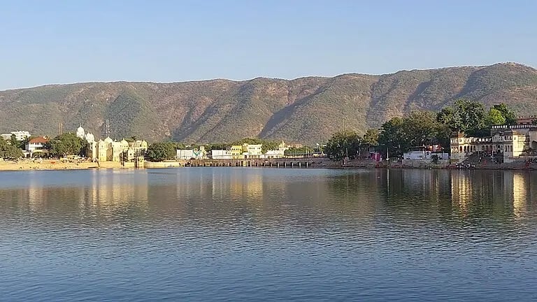Pushkar Lake in Rajasthan with holy ghats and temples reflecting in calm waters.