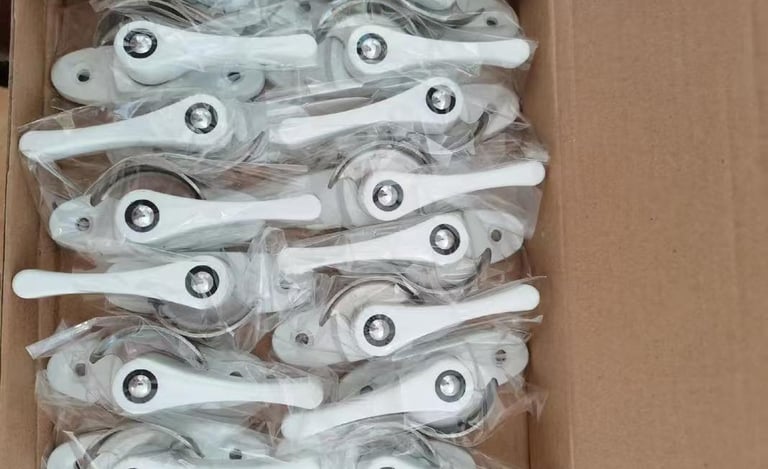 Box of white crescent window locks individually wrapped in plastic for secure window hardware installation.