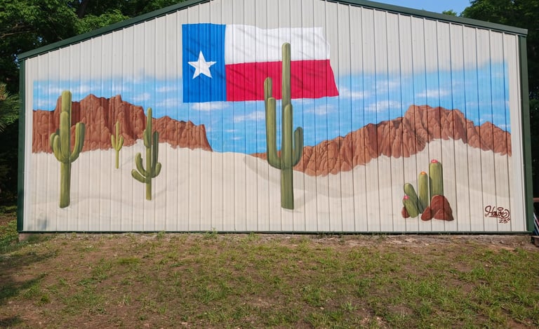 Mural of the Texas flag over a desert landscape with saguaro cacti painted on a metal building.