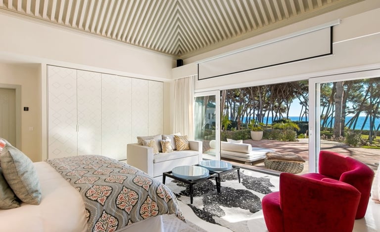 Master suite in the guest house of Villa El Rincon, Marbella, featuring stunning garden and sea views.