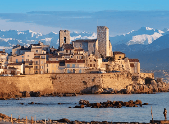 Antibes old town village on the sea with snowy mountains