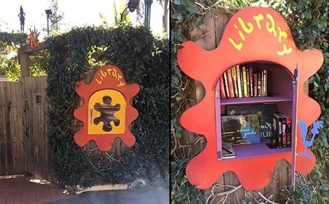 Red splatter-shaped library box with yellow door.