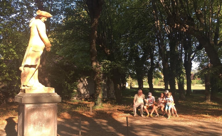 a group of people sitting on a bench in a park