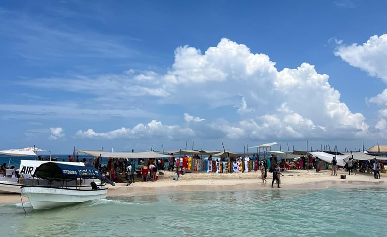 Tourists enjoying Nakupenda sandbank with traditional boat anchored in crystal-clear waters, Zanzibar, Tanzania