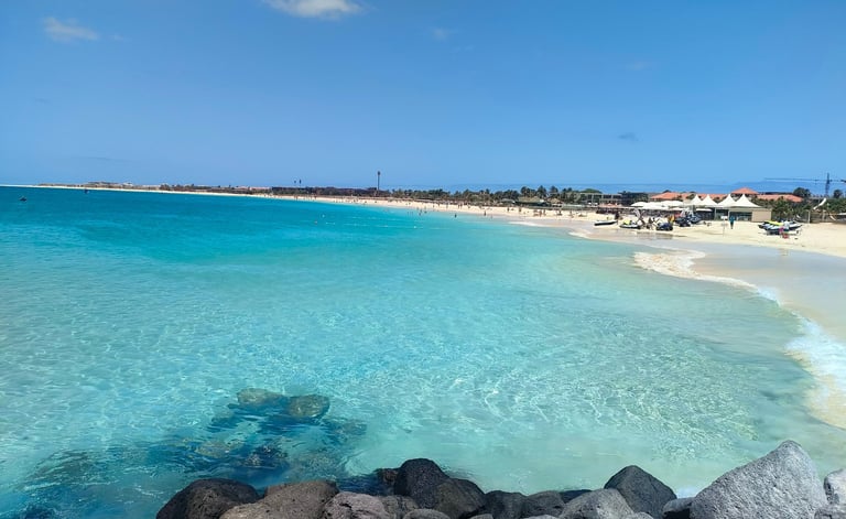 a beach with a blue sky and a clear blue sky