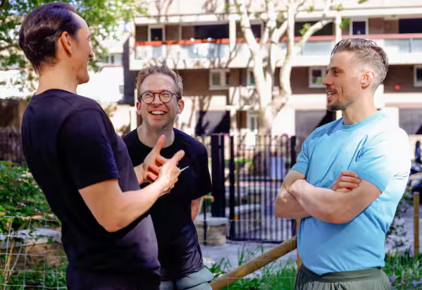 A personal trainer and his clients discussing exercise
