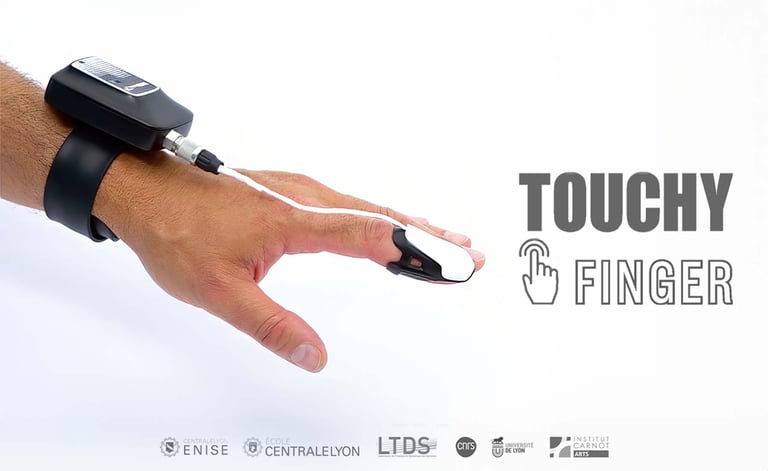 Touchy Finger wearable haptic sensor device worn on a hand for tactile digital interaction research.