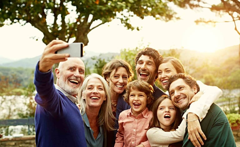 a group of people taking a selfie with a cell phone
