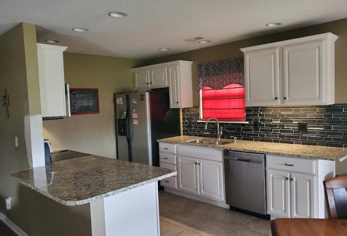 a kitchen with a table and chairs and a table
