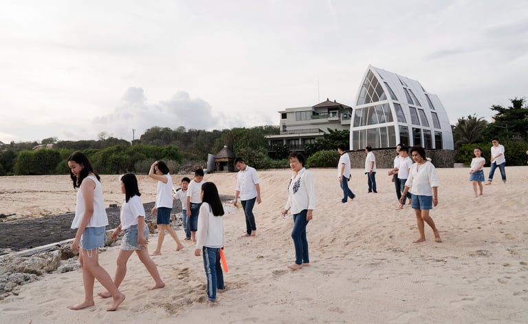 Family walking together near the beach and resort grounds during a lifestyle photography session at The Ritz-Carlton Bali