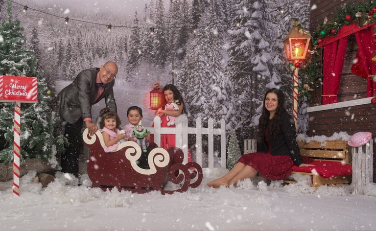 a family posing for a photo in a snowy scene