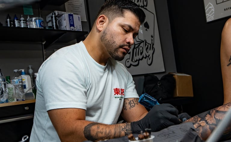 Junior doing a leg sleeve tattoo at royal nine tattoo