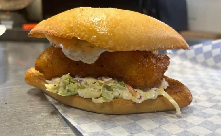 Fried fish sandwich with coleslaw and tartar sauce on a toasted bun from Captain’s Galley