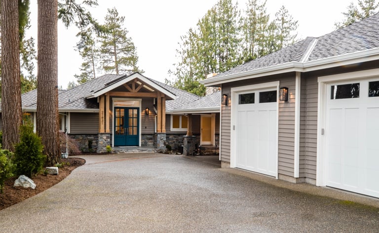 Front of the home with driveway and 2 car garage